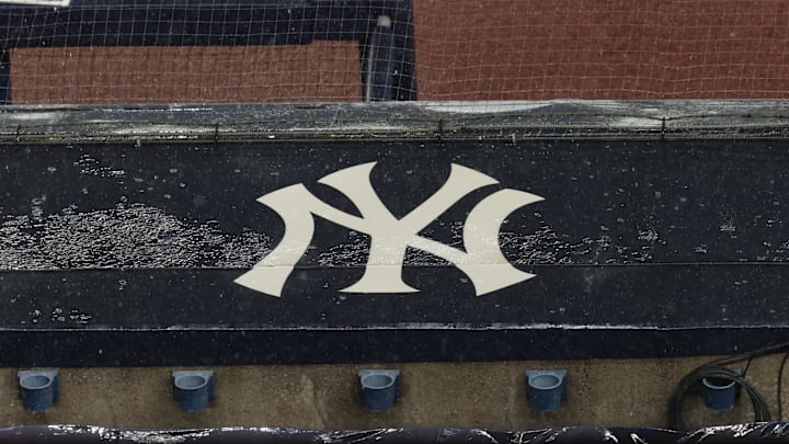 Aug 17, 2020; Bronx, New York, USA; A general view of rain falling on the  New York Yankees logo on the first base dugout roof during a rain delay in the game between the New York Yankees and the Boston Red Sox. Mandatory Credit: Vincent Carchietta-Imagn Images