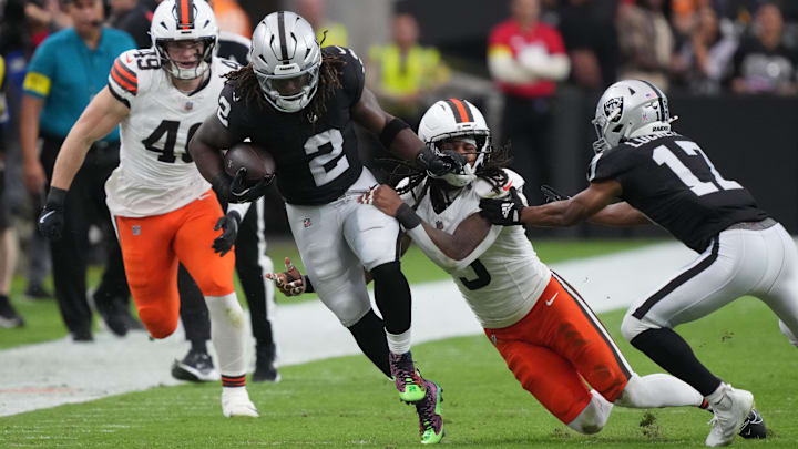 Nov 23, 2025; Paradise, Nevada, USA; Las Vegas Raiders running back Ashton Jeanty (2) carries the ball against Cleveland Browns safety Rayshawn Jenkins (5) in the first half at Allegiant Stadium. Mandatory Credit: Kirby Lee-Imagn Images