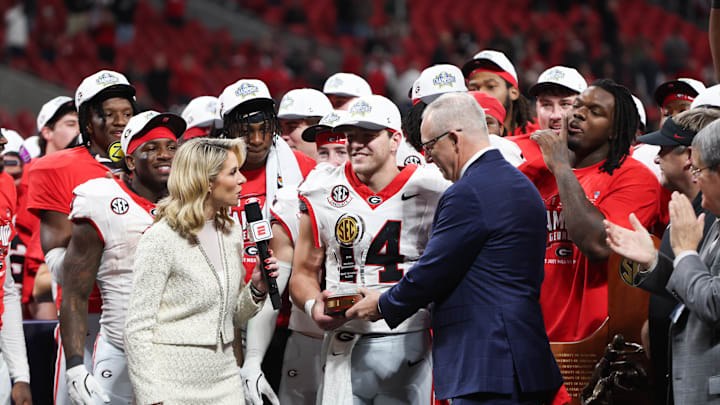 Dec 6, 2025; Atlanta, GA, USA; Georgia Bulldogs quarterback Gunner Stockton (14) is presented with the MVP trophy after the game against the Alabama Crimson Tide during the 2025 SEC Championship game at Mercedes-Benz Stadium. Mandatory Credit: Brett Davis-Imagn Images