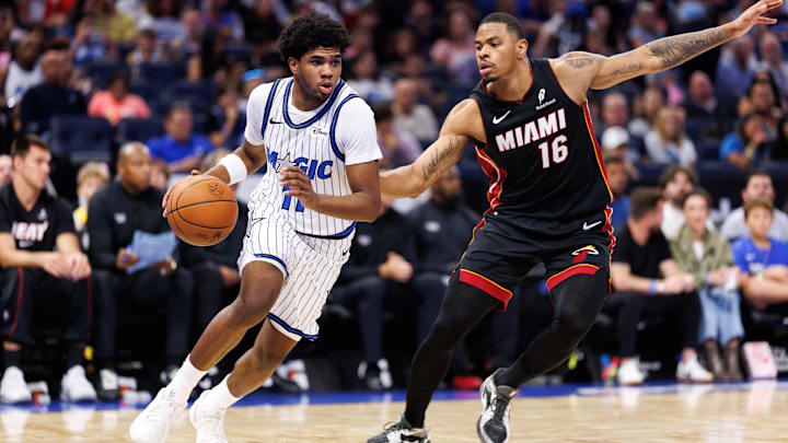 Oct 12, 2025; Orlando, Florida, USA; Orlando Magic guard Jase Richardson (11) drives to the basket while Miami Heat forward Keshad Johnson (16) defends during the second half at Kia Center. Mandatory Credit: Matt Pendleton-Imagn Images