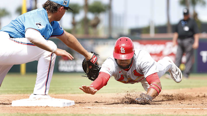 Mar 16, 2025; Jupiter, Florida, USA;  St. Louis Cardinals center fielder Victor Scott II (11) is picked off by Miami Marlins first baseman Jonah Bride (41) during the third inning  at Roger Dean Chevrolet Stadium. Mandatory Credit: Rhona Wise-Imagn Images