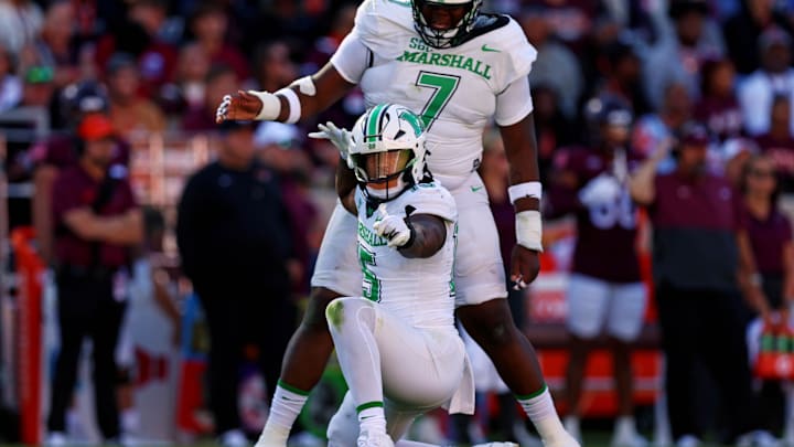 Sep 7, 2024; Blacksburg, Virginia, USA; Marshall Thundering Herd defensive lineman Mike Green (15) celebrates after sacking Virginia Tech Hokies quarterback Kyron Drones (1) during the first quarter at Lane Stadium. Mandatory Credit: Peter Casey-Imagn Images