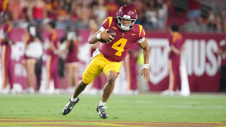 Aug 30, 2025; Los Angeles, California, USA; Southern California Trojans quarterback Husan Longstreet (4) carries the ball against the Missouri State Bears in the second half at United Airlines Field at Los Angeles Memorial Coliseum. Mandatory Credit: Kirby Lee-Imagn Images
