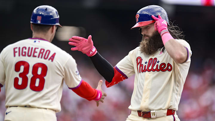 May 10, 2026; Philadelphia, Pennsylvania, USA; Philadelphia Phillies left fielder Brandon Marsh (16) is greeted by first base coach Paco Figueroa (38) after hitting a single against the Colorado Rockies during the third inning at Citizens Bank Park. 