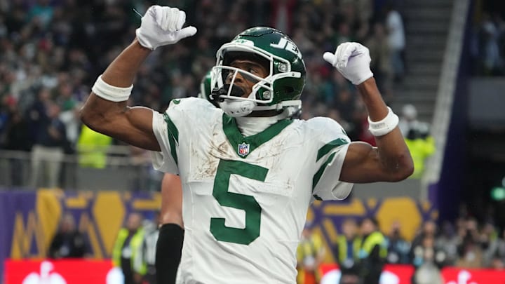 Oct 6, 2024; London, United Kingdom; New York Jets wide receiver Garrett Wilson (5) celebrates after scoring on a 1-yard touchdown reception against the New York Jets in the fourth quarter at Tottenham Hotspur Stadium.