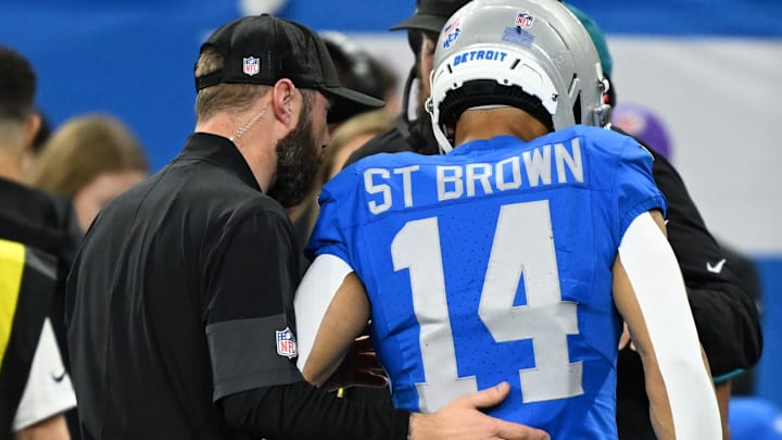Nov 27, 2025; Detroit, Michigan, USA; Detroit Lions wide receiver Amon-Ra St. Brown (14) is helped off the field against the Green Bay Packers during the first quarter at Ford Field. 