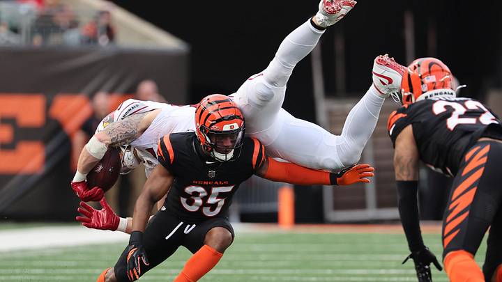 Dec 28, 2025; Cincinnati, Ohio, USA; Cincinnati Bengals cornerback Jalen Davis (35) tackles Arizona Cardinals tight end Trey McBride (85) during the second half at Paycor Stadium. Mandatory Credit: Joseph Maiorana-Imagn Images