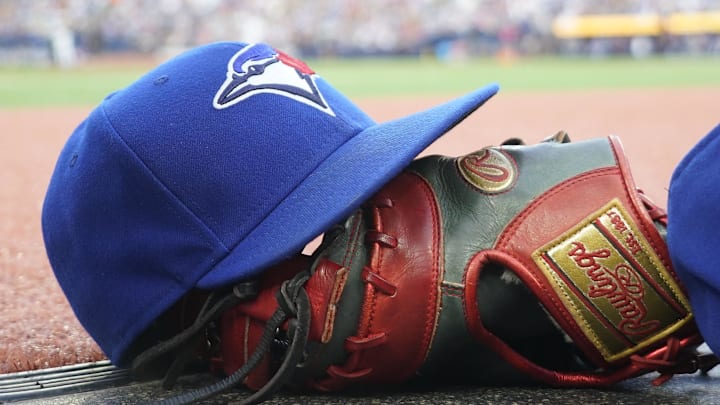 Jul 26, 2024; Toronto, Ontario, CAN; A Toronto Blue Jays hat and glove outside of the dugout during a game against the Texas Rangers at Rogers Centre.
