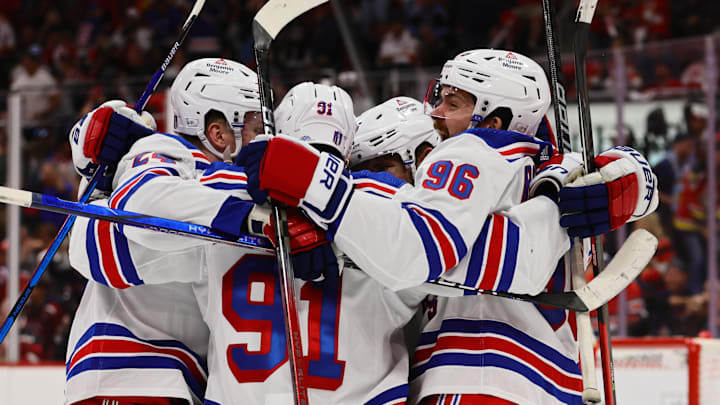 May 26, 2024; Sunrise, Florida, USA; New York Rangers center Alex Wennberg (91) celebrates with center Jack Roslovic (96) and right wing Kaapo Kakko (24) after scoring the game-winning goal in overtime against the Florida Panthers in game three of the Eastern Conference Final of the 2024 Stanley Cup Playoffs at Amerant Bank Arena. Mandatory Credit: Sam Navarro-Imagn Images