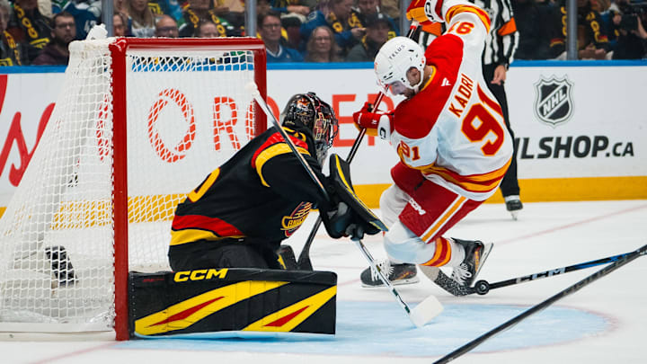 Oct 9, 2025; Vancouver, British Columbia, CAN; Vancouver Canucks goalie Thatcher Demko (35) makes a save on Calgary Flames forward Nazem Kadri (91) in the first period at Rogers Arena. Mandatory Credit: Bob Frid-Imagn Images