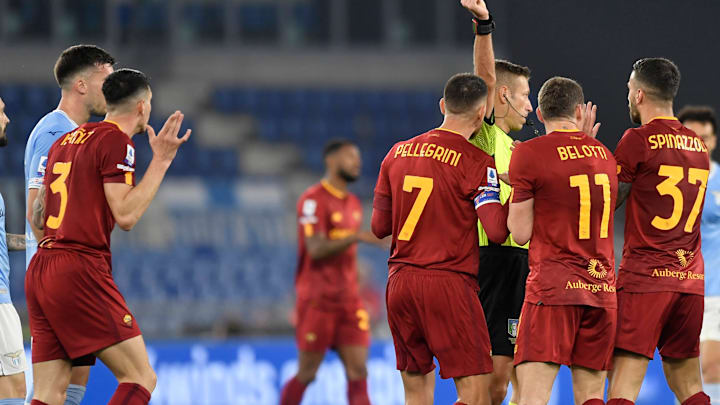 Referee Davide Massa shows a red card to Roger Ibanez of AS...