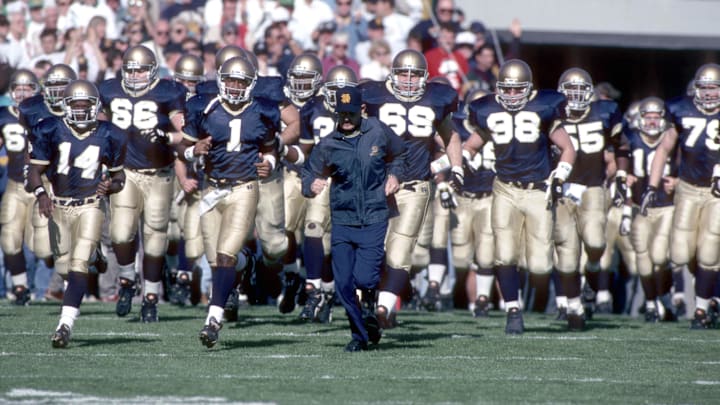 unknown date 1993; South Bend, IN, USA; FILE PHOTO; Notre Dame Irish head coach Lou Holtz leads his team onto the field during the 1993 season at Notre Dame Stadium. 