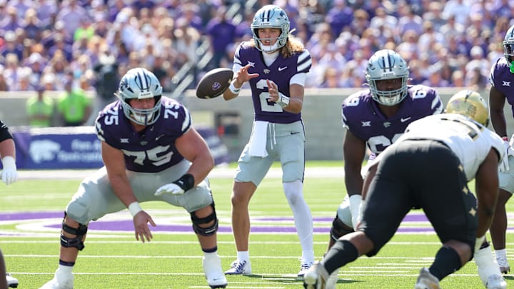 Kansas State Wildcats quarterback Avery Johnson takes the snap from center Sam Hecht. against UCF last season.