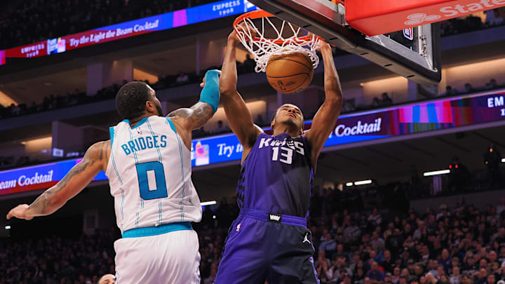 Jan 2, 2024; Sacramento, California, USA; Sacramento Kings forward Keegan Murray (13) dunks the ball against Charlotte Hornets forward Miles Bridges (0) during the second quarter at Golden 1 Center. Mandatory Credit: Kelley L Cox-Imagn Images