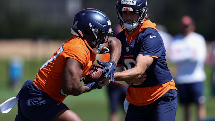May 23, 2024; Englewood, CO, USA; Denver Broncos quarterback Jarrett Stidham (8) and running back Audric Estime (37) during organized team activities at Centura Health Training Center.