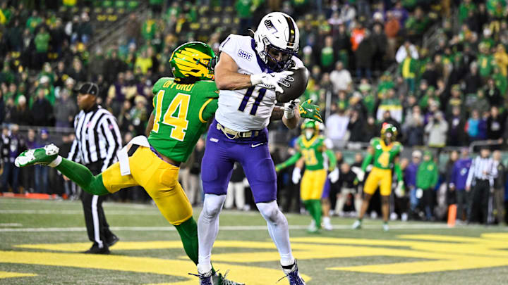 Dec 20, 2025; Eugene, OR, USA; James Madison Dukes wide receiver Nick Degennaro (11) makes a catch for a touchdown as Oregon Ducks defensive back Na'Eem Offord (14) defends during the fourth quarter at Autzen Stadium. Mandatory Credit: Craig Strobeck-Imagn Images