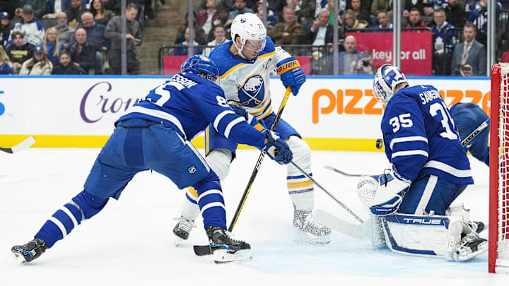 Mar 6, 2024; Toronto, Ontario, CAN; Buffalo Sabres right wing Kyle Okposo (21) battles for the puck