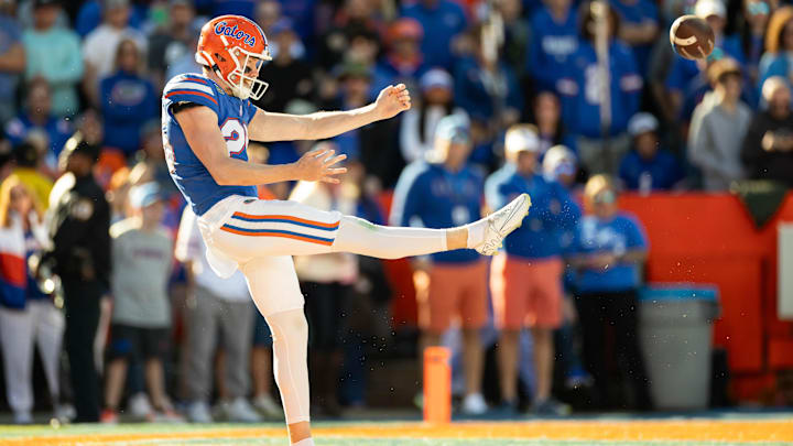 Nov 23, 2024; Gainesville, Florida, USA; Florida Gators punter Jeremy Crawshaw (26) punts the ball against the Mississippi Rebels during the second half at Ben Hill Griffin Stadium. Mandatory Credit: Matt Pendleton-Imagn Images