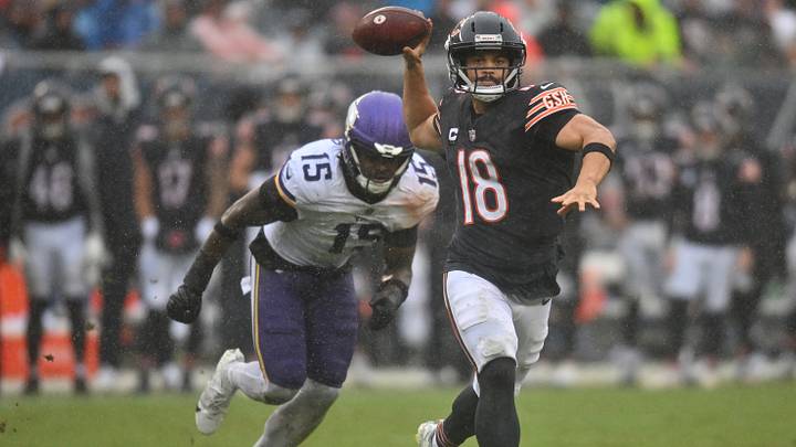 Chicago Bears quarterback Caleb Williams (18) throws a pass while scrambling against Minnesota Vikings linebacker Dallas Turner (15) during the second half at Soldier Field. Mandatory Credit: Patrick Gorski-Imagn Images Chicago Bears quarterback Caleb Williams (18) throws a pass while scrambling against Minnesota Vikings linebacker Dallas Turner (15) during the second half at Soldier Field. Mandatory Credit: Patrick Gorski-Imagn Images