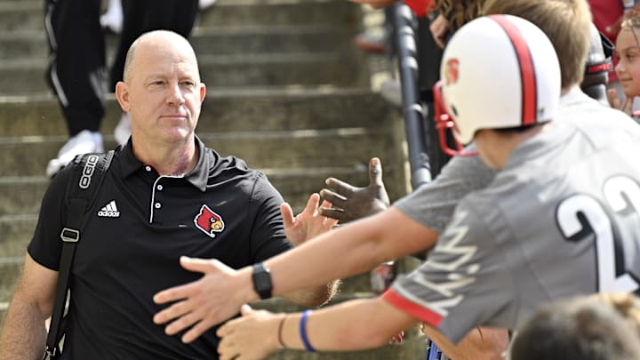 Sep 21, 2024; Louisville, Kentucky, USA; Louisville Cardinals head coach Jeff Brohm greets fans during the Card March before a game against the Georgia Tech Yellow Jackets at L&N Federal Credit Union Stadium. Mandatory Credit: Jamie Rhodes-Imagn Images Sep 21, 2024; Louisville, Kentucky, USA; Louisville Cardinals head coach Jeff Brohm greets fans during the Card March before a game against the Georgia Tech Yellow Jackets at L&N Federal Credit Union Stadium. Mandatory Credit: Jamie Rhodes-Imagn Images