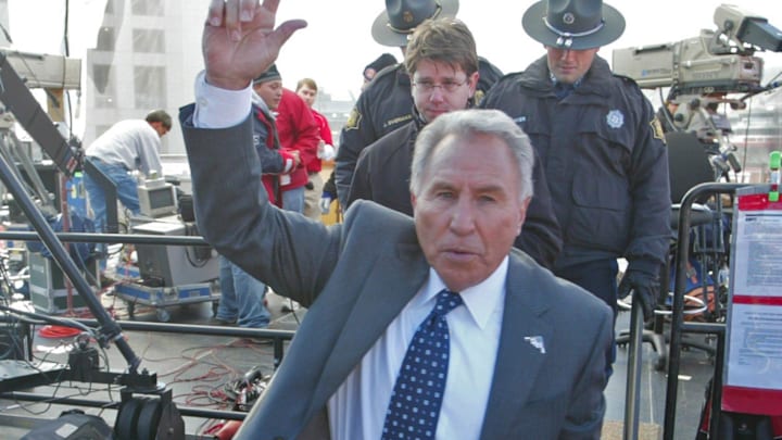 Lee Corso leaves the set of ESPN College GameDay is a weekly television program that airs during the college football season. The hosts are Kirk Herbstreit, Lee Corso, and Chris Fowler. The production was in Fayetteville, Arkansas Nov. 12 for the Arkansas/Tennessee game.