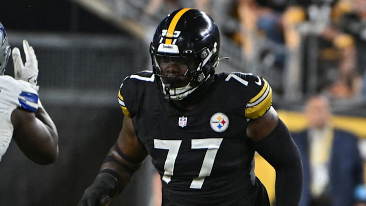 Oct 6, 2024; Pittsburgh, Pennsylvania, USA; Pittsburgh Steelers offensive tackle Broderick Jones (77) pass blocks during the first quarter against the Dallas Cowboys at Acrisure Stadium. Mandatory Credit: Barry Reeger-Imagn Images





