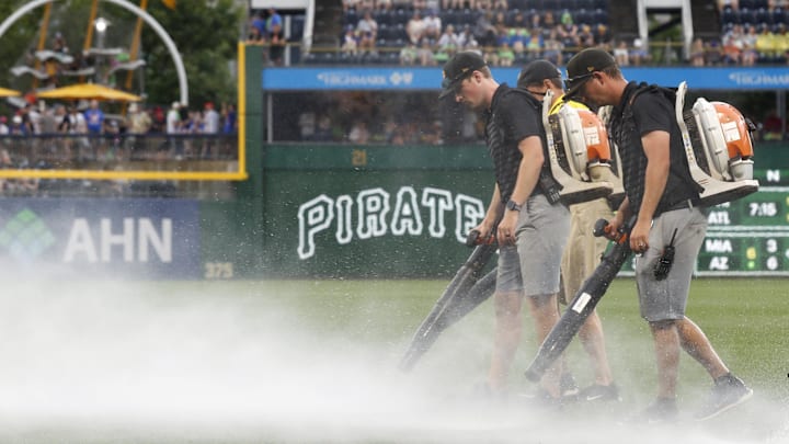 Jun 28, 2025; Pittsburgh, Pennsylvania, USA; The PNC Park grounds crew attempts to blow rain off of the playing surface in order to resume the game against the New York Mets after a rain delay halted play in the second inning at PNC Park. Mandatory Credit: Charles LeClaire-Imagn Images Jun 28, 2025; Pittsburgh, Pennsylvania, USA; The PNC Park grounds crew attempts to blow rain off of the playing surface in order to resume the game against the New York Mets after a rain delay halted play in the second inning at PNC Park. Mandatory Credit: Charles LeClaire-Imagn Images