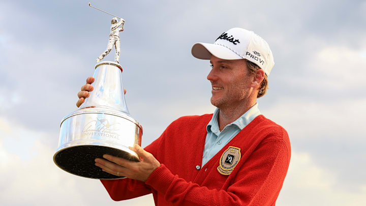 Russell Henley celebrates with the trophy after winning the 2025 Arnold Palmer Invitational at Bay Hill