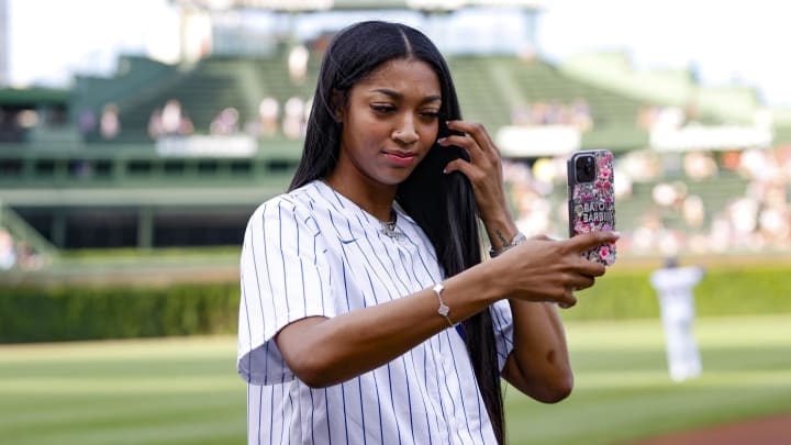 Chicago Sky forward Angel Reese prepares to throw out a ceremonial first pitch before a baseball game between the Chicago Cubs and Atlanta Braves at Wrigley Field.