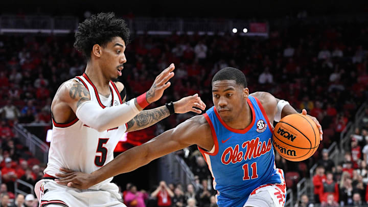 Dec 3, 2024; Louisville, Kentucky, USA; Mississippi Rebels guard Matthew Murrell (11) dribbles against Louisville Cardinals guard Terrence Edwards Jr. (5) during the first half at KFC Yum! Center. Mississippi defeated Louisville 86-63. Mandatory Credit: Jamie Rhodes-Imagn Images Dec 3, 2024; Louisville, Kentucky, USA; Mississippi Rebels guard Matthew Murrell (11) dribbles against Louisville Cardinals guard Terrence Edwards Jr. (5) during the first half at KFC Yum! Center. Mississippi defeated Louisville 86-63. Mandatory Credit: Jamie Rhodes-Imagn Images