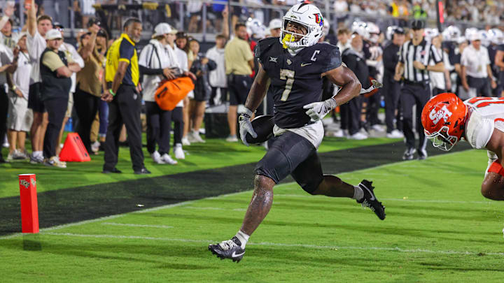Sep 7, 2024; Orlando, Florida, USA; UCF Knights running back RJ Harvey (7) scores a touchdown during the second quarter against the Sam Houston State Bearkats at FBC Mortgage Stadium. Mandatory Credit: Mike Watters-Imagn Images