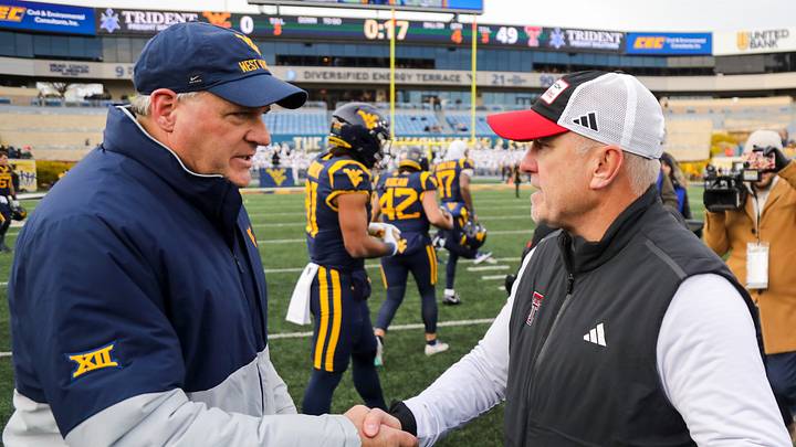 Nov 29, 2025; Morgantown, West Virginia, USA; West Virginia Mountaineers head coach Rich Rodriguez talks with Texas Tech Red Raiders head coach Joey McGuire after the game at Milan Puskar Stadium. Mandatory Credit: Ben Queen-Imagn Images Nov 29, 2025; Morgantown, West Virginia, USA; West Virginia Mountaineers head coach Rich Rodriguez talks with Texas Tech Red Raiders head coach Joey McGuire after the game at Milan Puskar Stadium. Mandatory Credit: Ben Queen-Imagn Images