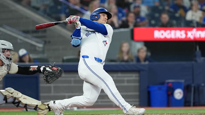 May 18, 2025; Toronto, Ontario, CAN; Toronto Blue Jays centre ielder Daulton Varsho (5) hits a double against the Detroit Tigers during the fourth inning at Rogers Centre. 