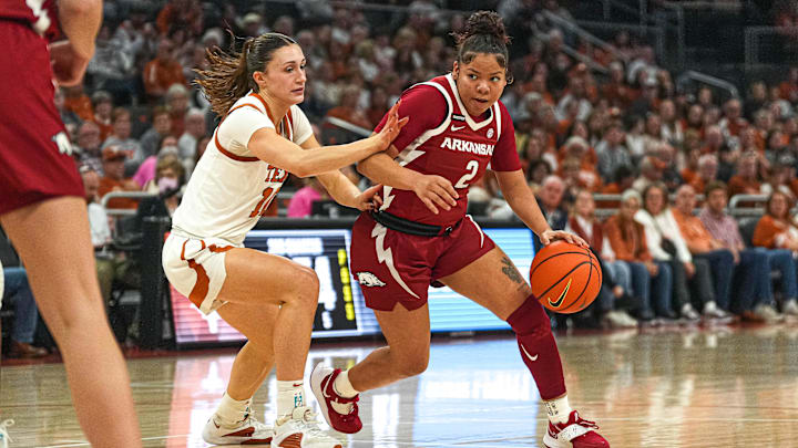 Arkansas guard Kiki Smith (2) pushes past Texas Longhorns guard Shay Holle (10)