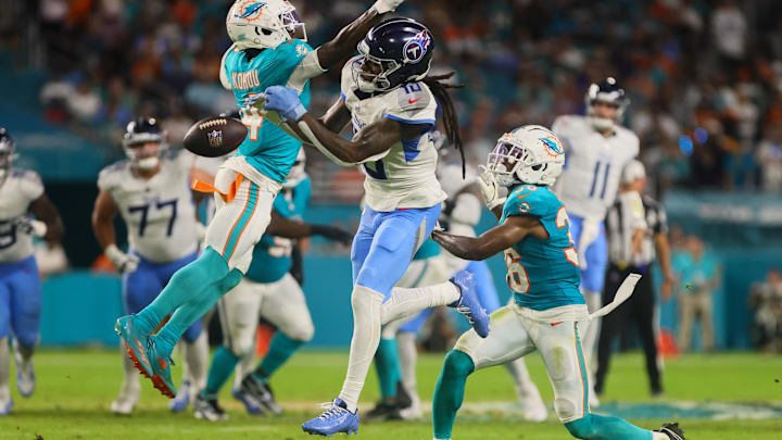 Sep 30, 2024; Miami Gardens, Florida, USA; Tennessee Titans wide receiver DeAndre Hopkins (10) jumps but cannot make a catch against Miami Dolphins cornerback Kader Kohou (4) and cornerback Storm Duck (36) during the second quarter at Hard Rock Stadium. Mandatory Credit: Sam Navarro-Imagn Images