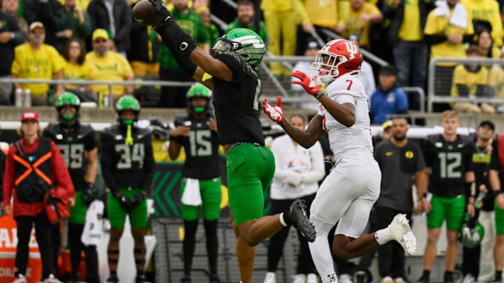 Oct 11, 2025; Eugene, Oregon, USA; Oregon Ducks defensive back Brandon Finney Jr. (4) intercepts a pass intended for Indiana Hoosiers wide receiver E.J. Williams Jr. (7) during the third quarter at Autzen Stadium. Mandatory Credit: Troy Wayrynen-Imagn Images