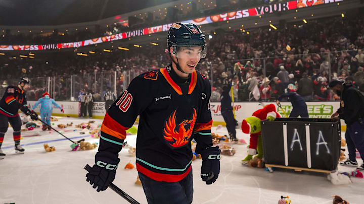Coachella Valley forward Luke Henman smiles as he skates around the ice as the teddy bears are thrown onto the ice after his goal in the first period of their game at Acrisure Arena in Palm Desert, Calif., Saturday, Dec. 28, 2024.