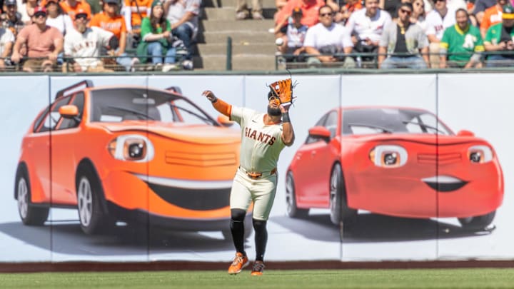 May 18, 2025; San Francisco, California, USA; San Francisco Giants outfielder Heliot Ramos (17) makes a catch in the outfield during the ninth inning against the Oakland Athletics at Oracle Park. Mandatory Credit: Bob Kupbens-Imagn Images