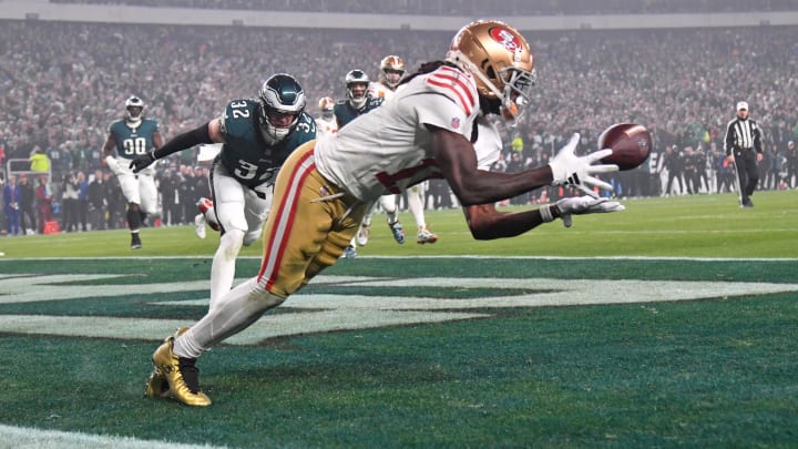 Dec 3, 2023; Philadelphia, Pennsylvania, USA; San Francisco 49ers wide receiver Brandon Aiyuk (11) catches touchdown pass against Philadelphia Eagles safety Reed Blankenship (32) during the second quarter at Lincoln Financial Field. Mandatory Credit: Eric Hartline-USA TODAY Sports