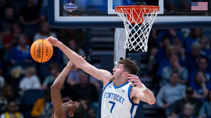 Kentucky Wildcats forward Andrew Carr (7) blocks the shot of Oklahoma Sooners forward Jalon Moore (14) during their second round game of the SEC Men's Basketball Tournament at Bridgestone Arena in Nashville, Tenn., Thursday, March 13, 2025.
