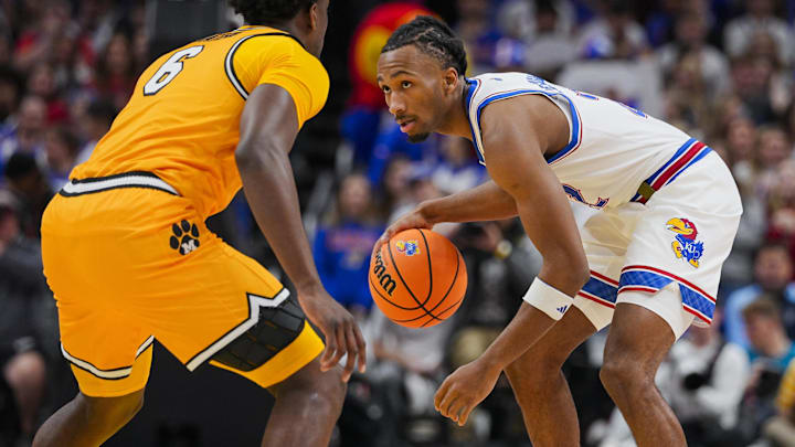 Dec 7, 2025; Kansas City, Missouri, USA; Kansas Jayhawks guard Darryn Peterson (22) dribbles the ball against Missouri Tigers guard Annor Boateng (6) during the first half at T-Mobile Center. Mandatory Credit: Jay Biggerstaff-Imagn Images
