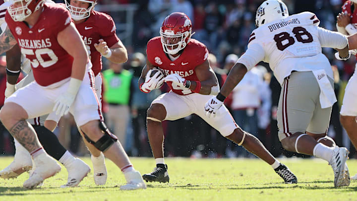 Nov 1, 2025; Fayetteville, Arkansas, USA; Arkansas Razorbacks running back Mike Washington Jr (4) rushes during the first quarter against the Mississippi State Bulldogs at Donald W. Reynolds Razorback Stadium. Mandatory Credit: Nelson Chenault-Imagn Images