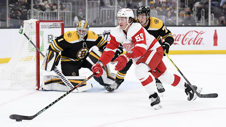 Nov 4, 2021; Boston, Massachusetts, USA;  Detroit Red Wings left wing Tyler Bertuzzi (59) looks to gain control of the puck in front of Boston Bruins goaltender Jeremy Swayman (1) while defenseman Charlie McAvoy (73) defends during the second period at TD Garden. Mandatory Credit: Bob DeChiara-Imagn Images