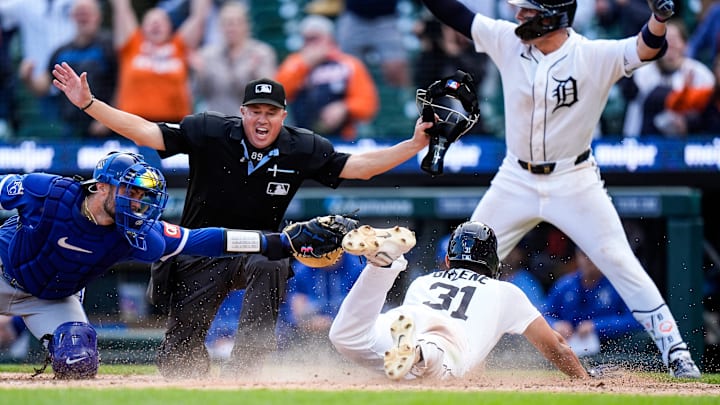 Detroit Tigers left fielder Riley Greene (31) slides into home against Kansas City Royals catcher Carter Jensen (22) to score a run.