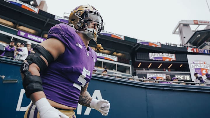 Zach Durfee takes the field with his right elbow in a brace for the 2024 Apple Cup.