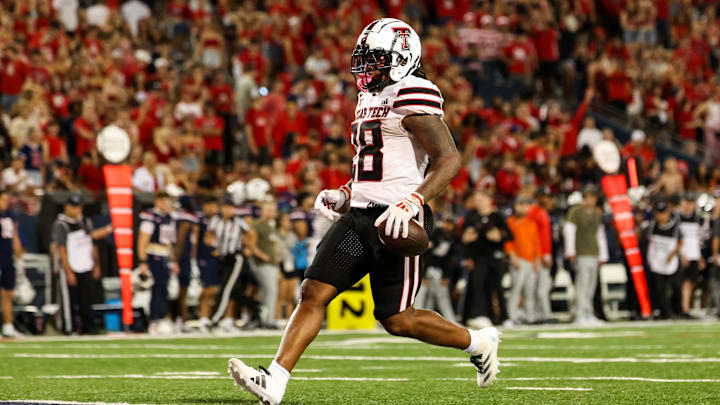 Texas Tech Red Raiders running back Tahj Brooks scores a touchdown against Arizona Wildcats. Texas Tech Red Raiders running back Tahj Brooks scores a touchdown against Arizona Wildcats.