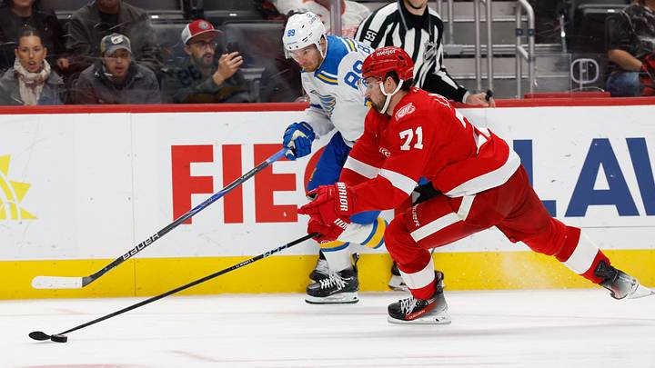 Oct 25, 2025; Detroit, Michigan, USA;  St. Louis Blues left wing Pavel Buchnevich (89) and Detroit Red Wings center Dylan Larkin (71) battle for the puck in the third period at Little Caesars Arena. Mandatory Credit: Rick Osentoski-Imagn Images