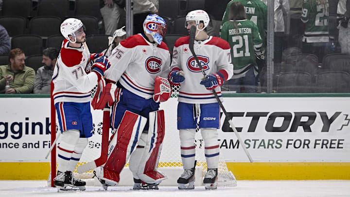 Jan 16, 2025; Dallas, Texas, USA; Montreal Canadiens center Kirby Dach (77) and goaltender Jakub Dobes (75) and defenseman Arber Xhekaj (72) celebrate on the ice after defeating the Dallas Stars at the American Airlines Center. Mandatory Credit: Jerome Miron-Imagn Images