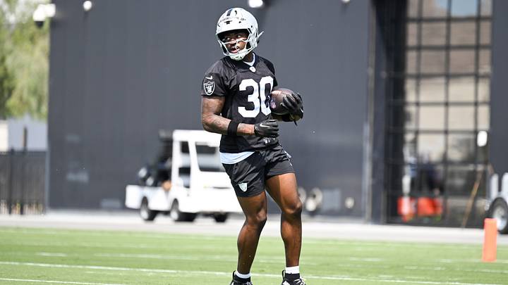 Las Vegas Raiders running back Mike Washington Jr. (30) runs through a drill during a Rookie Minicamp at Intermountain Health Performance Center. Las Vegas Raiders running back Mike Washington Jr. (30) runs through a drill during a Rookie Minicamp at Intermountain Health Performance Center.