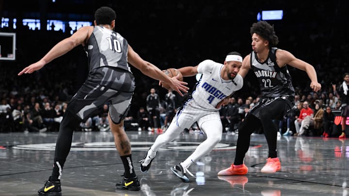 Orlando Magic guard Jalen Suggs (4) drives to the basket while being defended by Brooklyn Nets guard Ben Simmons (10) and Brooklyn Nets forward Jalen Wilson (22) during the first half at Barclays Center.